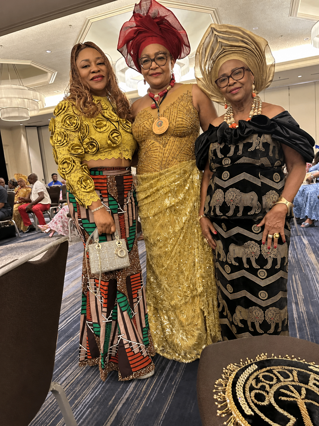 Three Ngwa women dressed in formal attire at a celebration.